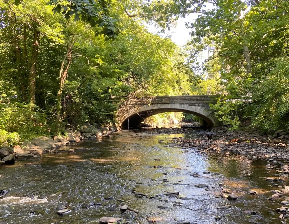 The Bronx River flowing under a stone bridge